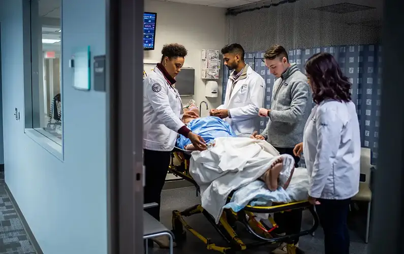 Medical students work with a mannequin to simulate real-world patient care in a safe learning environment