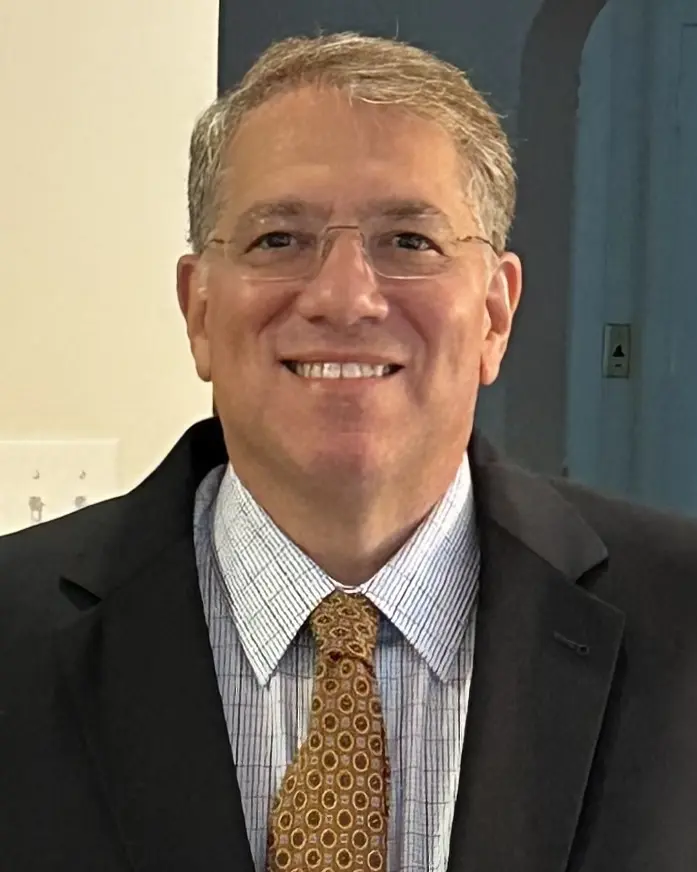 Headshot photo of PCOM's Matthew D. Weinberg, MB, wearing a suit