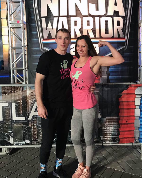 Alyssa Varsalona poses with another contestant under the American Ninja Warrior sign