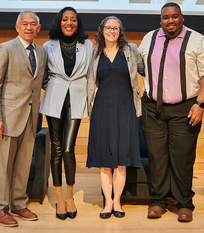 PCOM admissions staff Kari Shotwell, MS/ODL '10, and John Hill smile with other panel guests