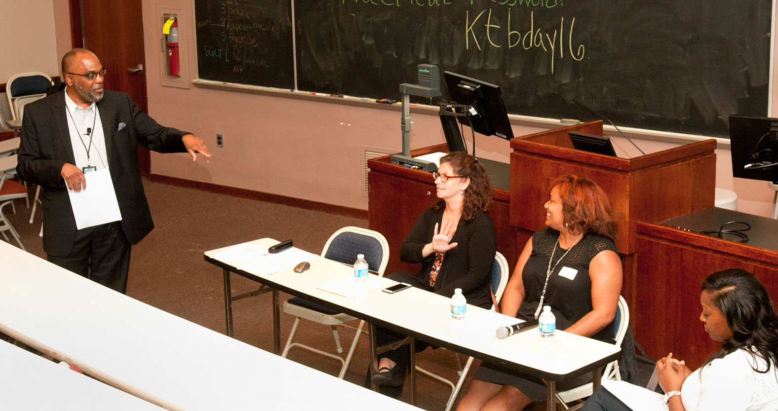 Jeff Branch, EdD, and other PCOM faculty teach students at the front of a lecture hall