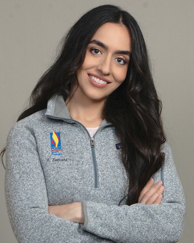 PCOM medical student Shahrzad Zamani (DO '25) smiling in a PCOM fleece