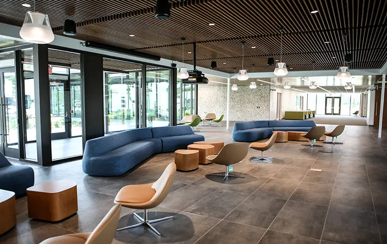 Lobby with ample seating and floor-to-ceiling windows offering views of the front and rear courtyards